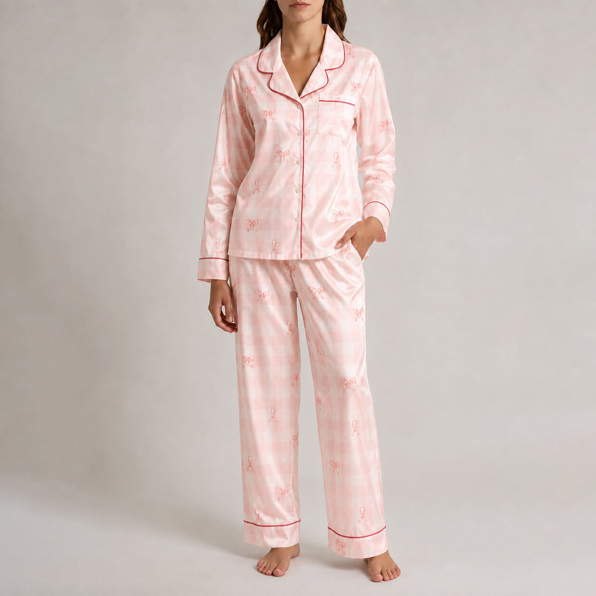 Front view of women’s pink gingham satin button-up pajama set