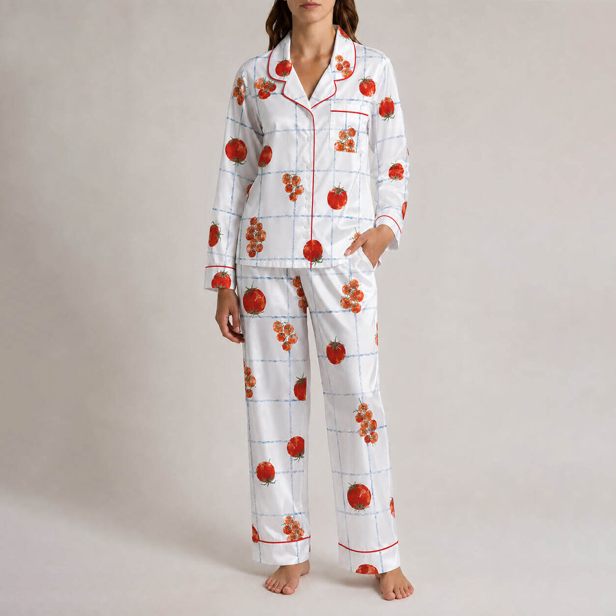 Front view of women’s white satin pajamas with red fruit pattern